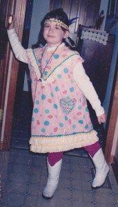 Notice the generous amounts of rickrack not only on her costume, but also braided to make the headpiece.   