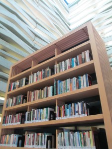Walls of concrete and glass reach to the sky around the bookcases.