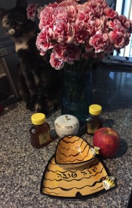 Honey, apples, serving dishes, flowers and my kitten make the holiday sweet and happy.